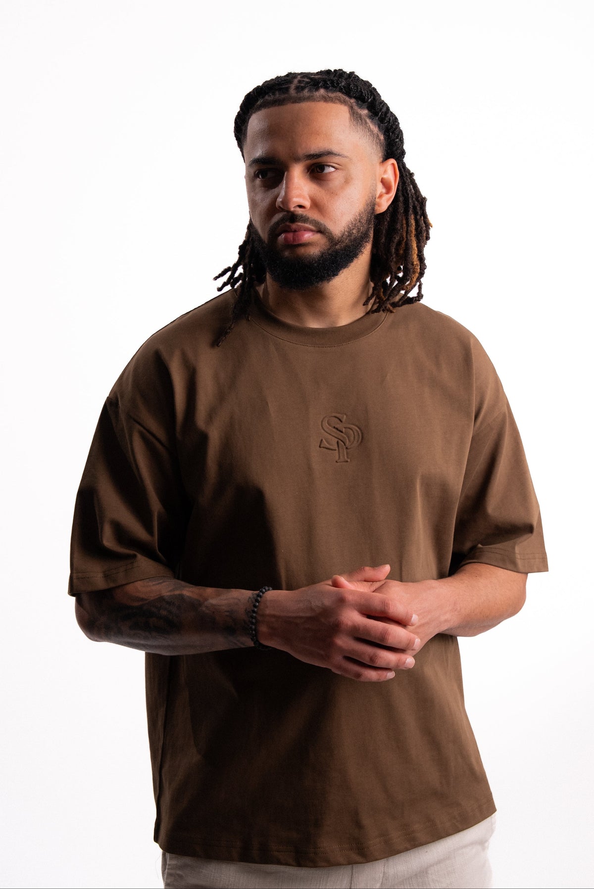 Model wearing the SILNTPLAY Embossed Tee in Claystone