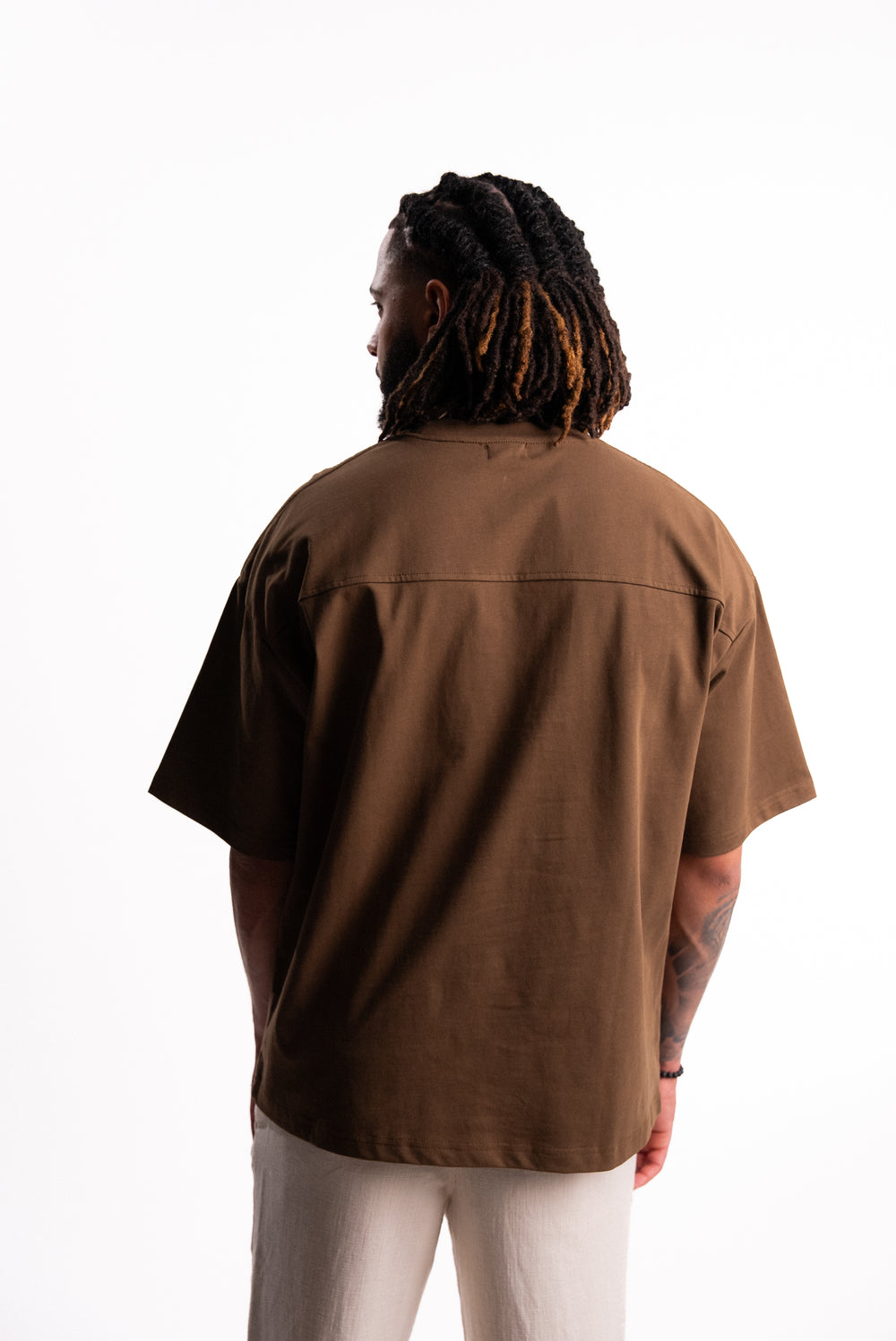 Model wearing the SILNTPLAY Embossed Tee in Claystone