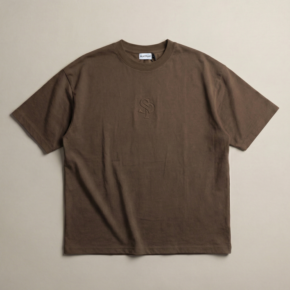 The SILNTPLAY Embossed Tee in Claystone, front flatlay