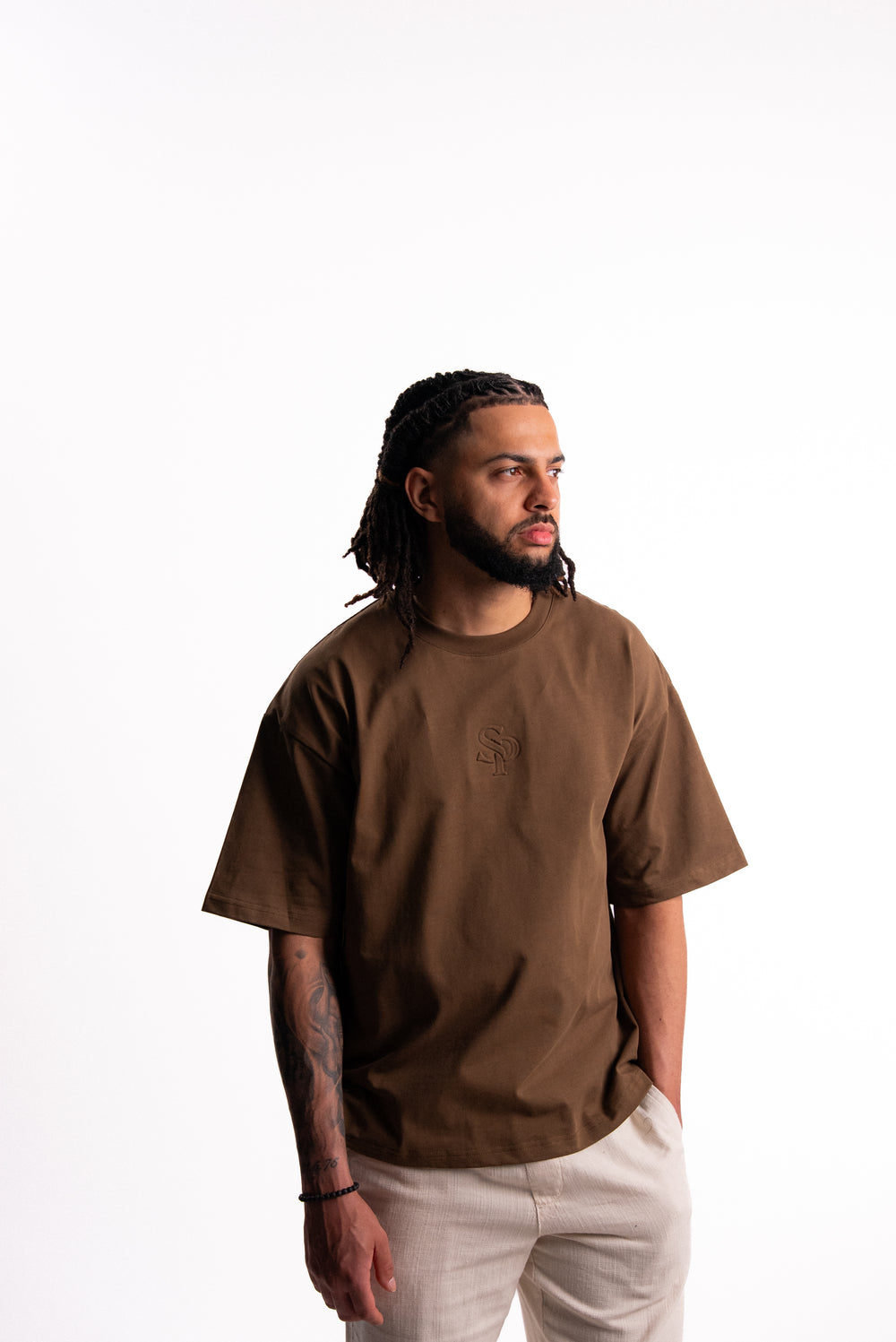 Back view of the SILNTPLAY Embossed Tee in Claystone
