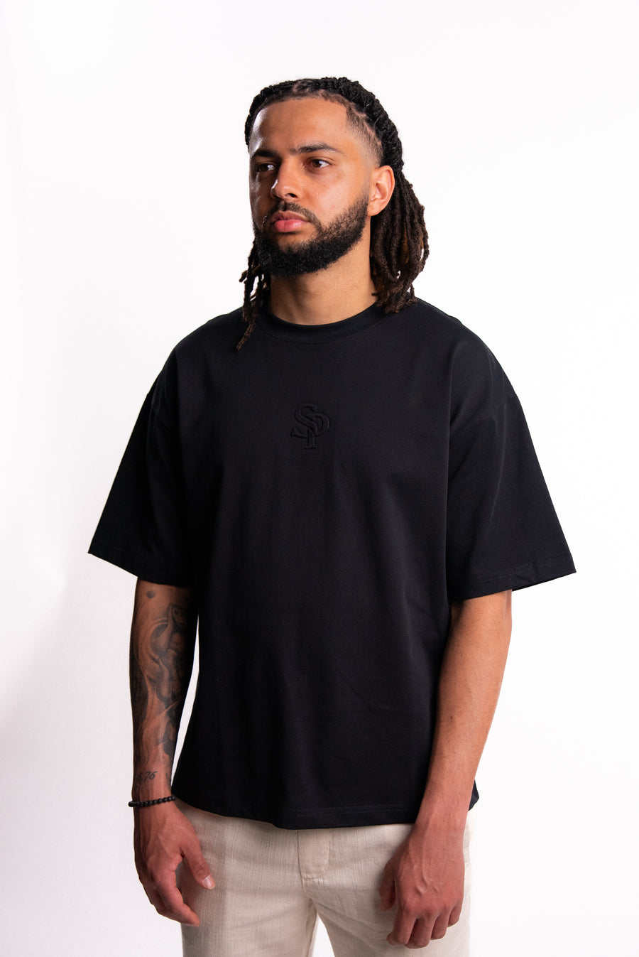 Model wearing the SILNTPLAY Embossed Tee in Obsidian